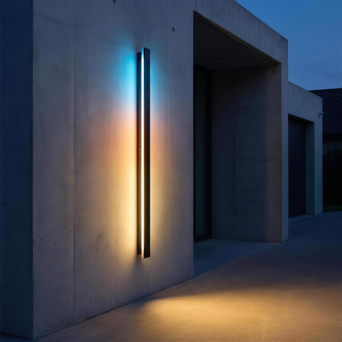 Lumea wall light on a concrete entrance wall at blue hour