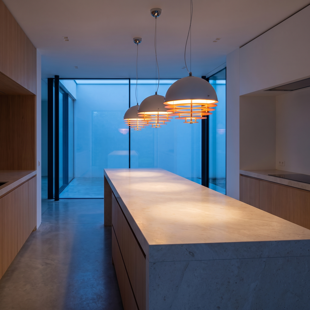Three Solera pendant lights over a kitchen island