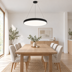 Black LED ring pendant light over Scandinavian dining table