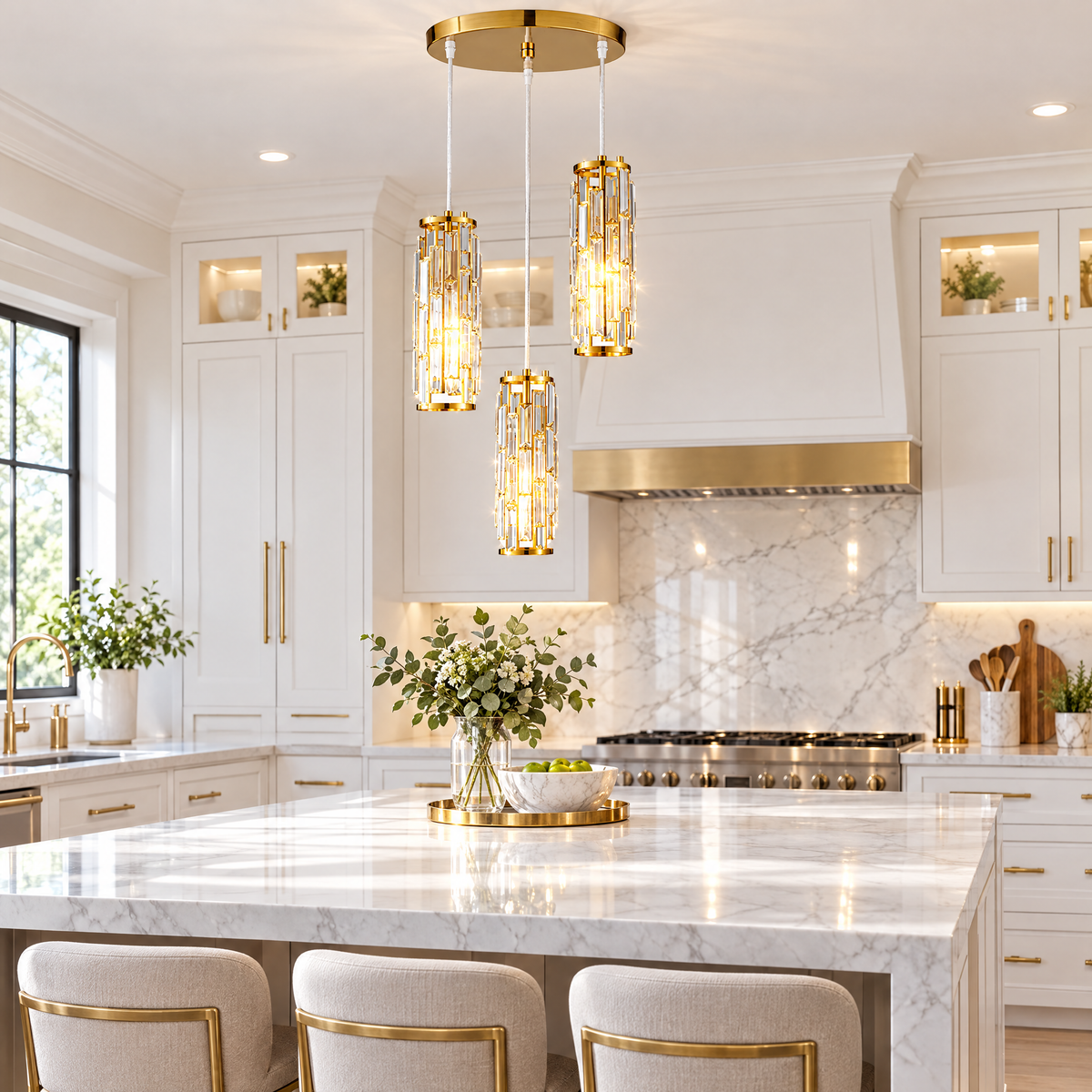 Gold crystal pendant light over marble kitchen island