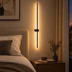 Ultra-thin black linear LED wall light bar beside a bed in a bedroom