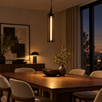 Black industrial tube pendant light with glass cylinder above a dining table in a modern dining room