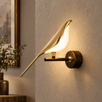 Gold bird wall light with glass bird close-up on the wall