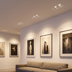 Twin rectangular double-head recessed spotlight several are recessed in the ceiling of a modern living room