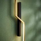 Lyre gold linear line-art LED wall sconce close-up detail lit up