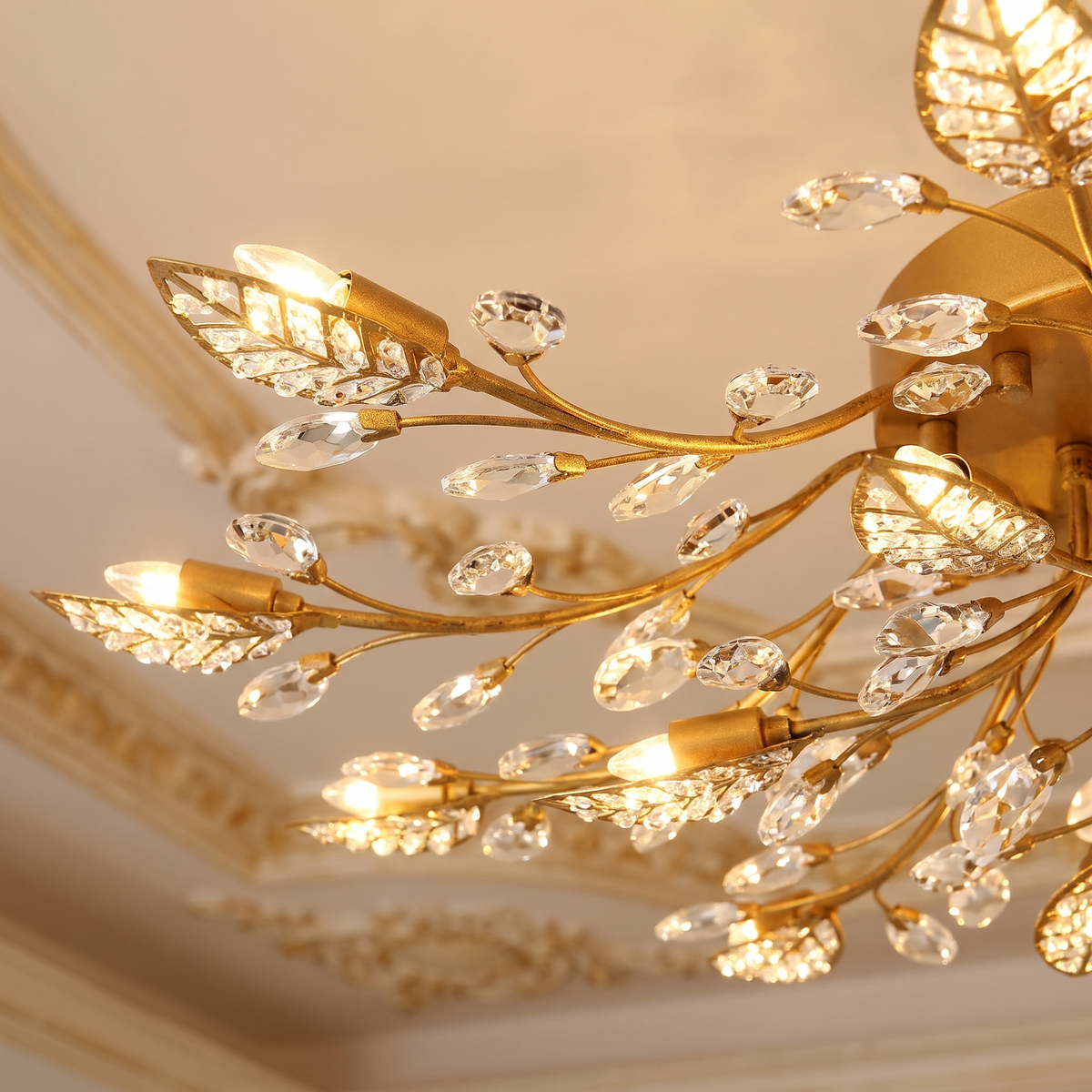 Fiora brass branch crystal chandelier with leaves close-up detail lit up