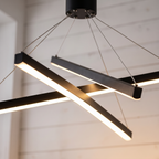 Criss crossed-bar linear LED chandelier close-up detail lit up