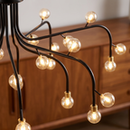 Retro adjustable branching chandelier with glass spheres close-up detail lit up