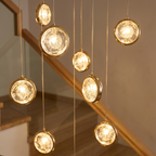 Cascade long crystal globe staircase chandelier close-up detail lit up