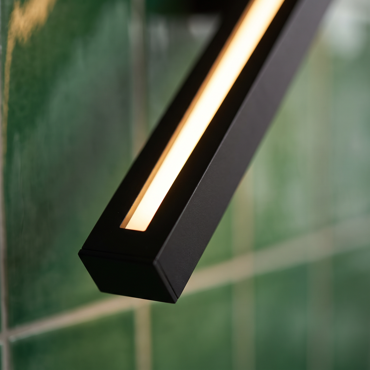 Linden long vertical black linear LED wall sconce close-up detail lit up