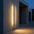 Lumea wall light on a concrete entrance wall at blue hour