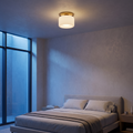Perla flush mount ceiling light in a bedroom at dusk